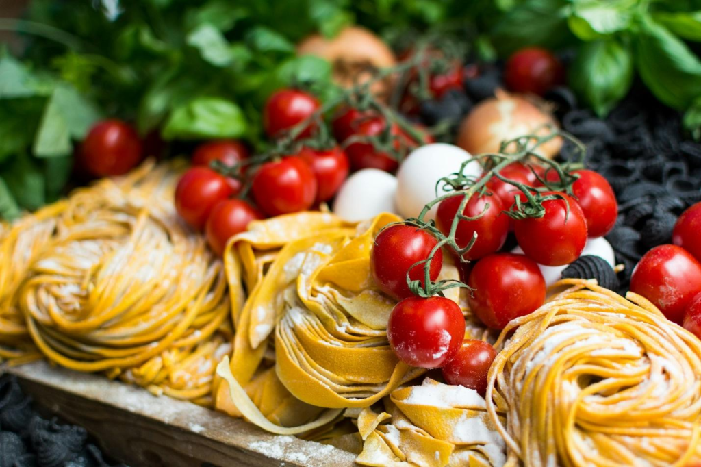 A plate of pasta with cherry tomatoes and cheese