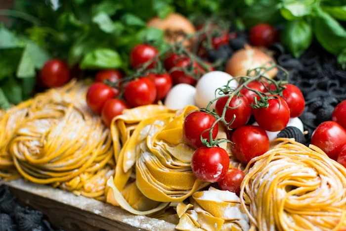Different types of pasta with cheese and cherry tomatoes