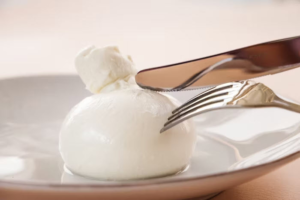 Fork and knife on the burrata cheese