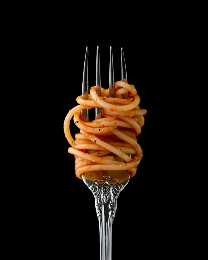 A fork with spaghetti around it 