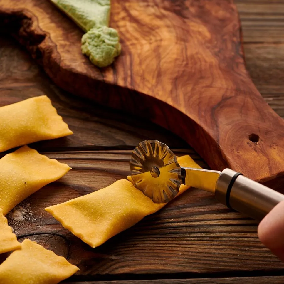 A person cutting the stuffed ravioli
