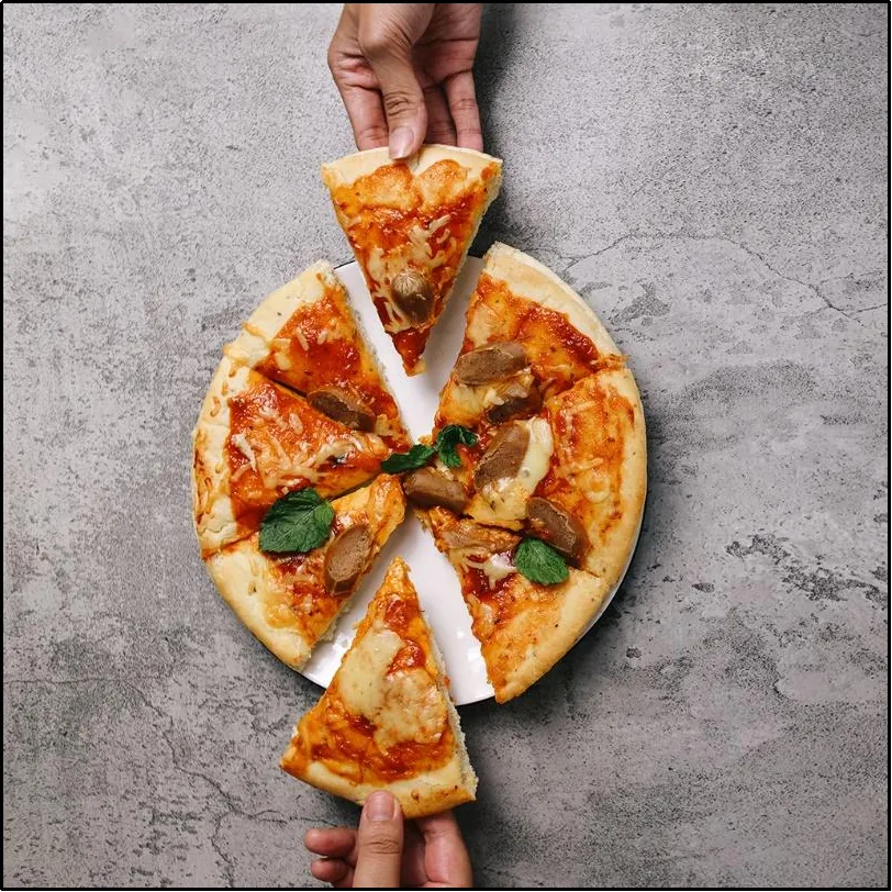Two people taking one pizza slice each