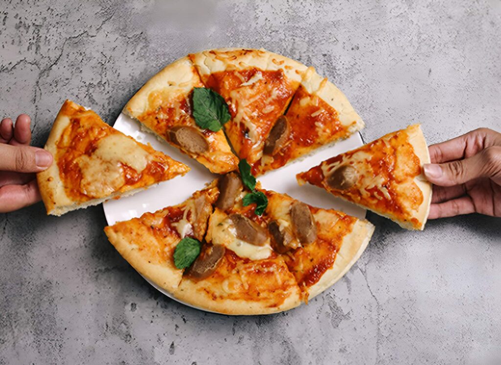 Top-down view of a person holding a sliced authentic Neapolitan pizza