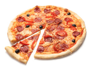 A pepperoni pizza topped with tomato slices and black olives, with one slice pulled slightly away from the whole pie on a white background.