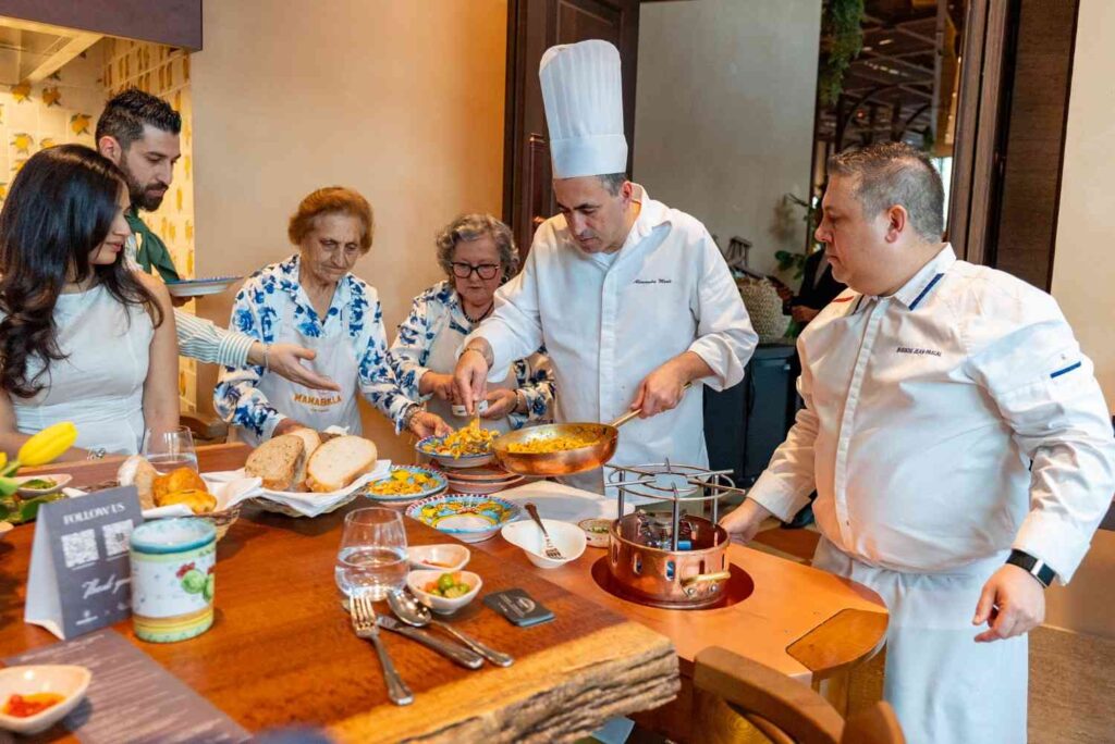 chef serving food at MamaBella restaurant