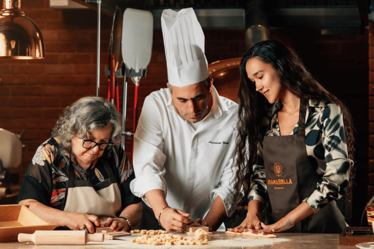 Mamabella chef and noona preparing fresh handmade pasta together in the restaurant kitchen.